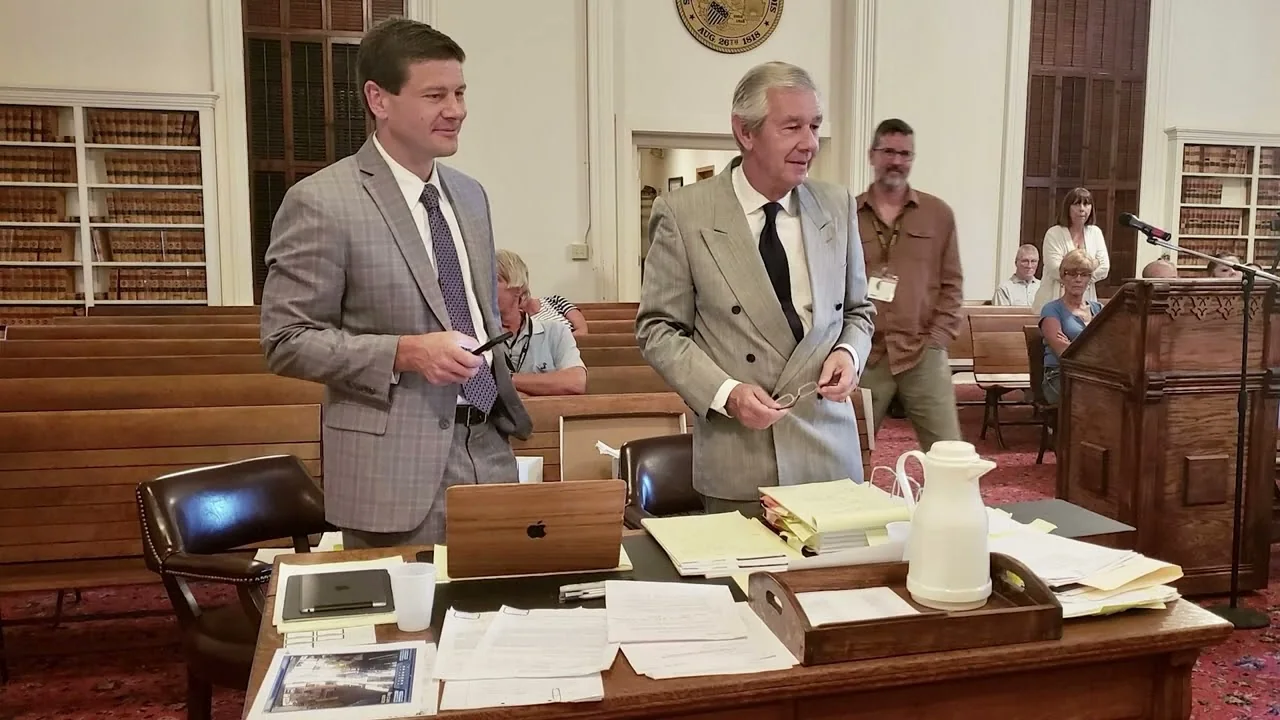 Robert and Drew Parker in gray suits at counsel table during a Putnam County trial in Hennepin, Illinois, 2018