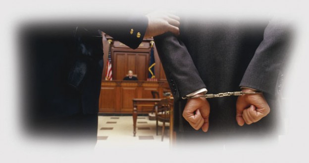 Man in handcuffs in court room